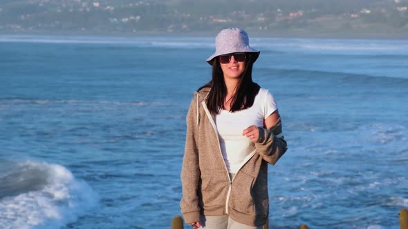 beautiful girl portrait with bucket hat on the beach, pichilemu, punta de lobos. chile, surf beach