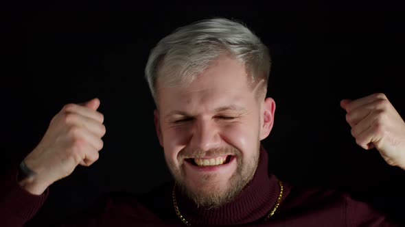 Closeup of Stylish Handsome Man with Blue Eyes Dancing to Music Rhythmically to Beat Moving Hands alt