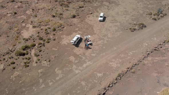 aerial rotating shot of a water point in a mountain bike race alt