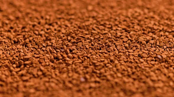 Full Frame Slowly Spinning Background of Freezedried Instant Coffee Granules Extreme Closeup with