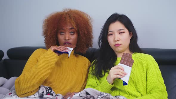 Two Women Lesbian Couple Watching Television and Eating Chocolates alt