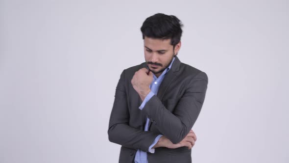 Young Bearded Indian Businessman Thinking alt