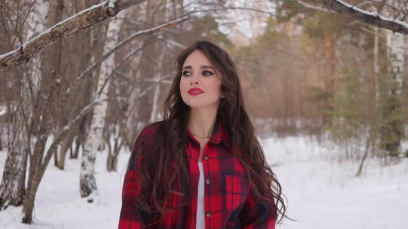 Charming Female with Long Hair Walking in Snowy Forest