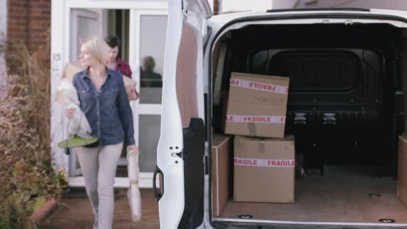 Adult Couple moving out of home with boxes and homeware