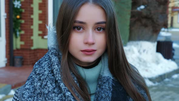 A Portrait of a Beautiful Young Woman in a Winter Street alt