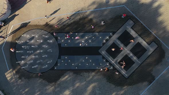 Children Play in the City Fountain in the Summer in the Heat in Minsk alt