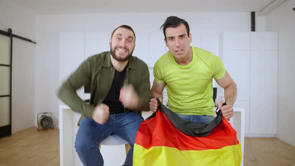Cheerful German Sport Fans Rejoicing Victory of Favorite Team Watching TV Indoors alt