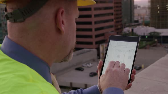 Construction manager looking at plans on touch screen