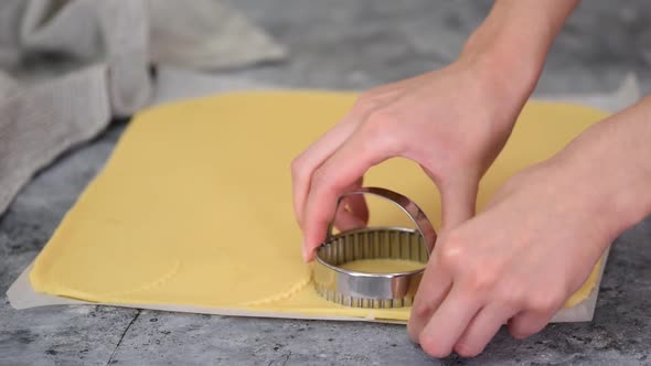 Woman Cuts Out Dough Circles with Round Mold for Making Sweet Cookies