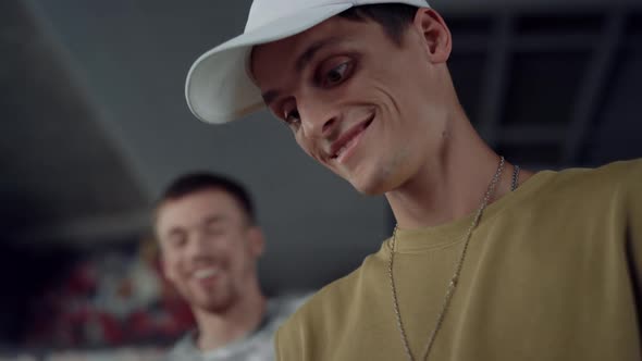 Excited People Surfing Internet on Mobile Phone at Skate Park alt