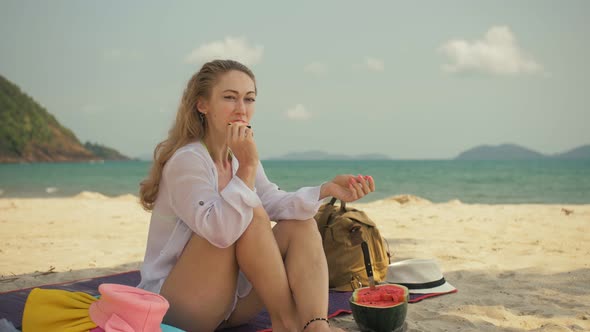 The Cheerful Woman in Holding and Eating Slices of Watermelon on Tropical Sand Beach Sea. Portrait alt