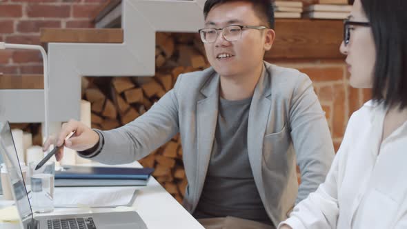 Pair of Asian Businesspeople Working Together alt