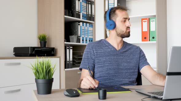 Creative Person Works Using a Digital Tablet and Draws alt