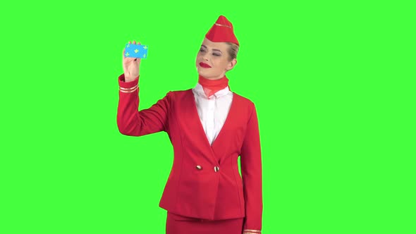 Girl Raises a Card and Shows a Points a Hand at Her. Green Screen alt