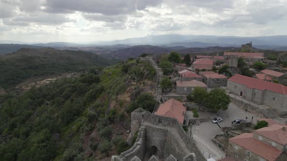 Aerial reveals main keep and historical village of Sortelha Fortress, Portugal