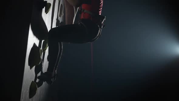 Handheld Professional Climbers Training on a Steep Wall Practicing Rockclimbing and Descends From alt
