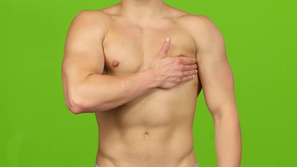 Man Suffers From Pain in Breast Muscle, Green Screen. Closeup alt