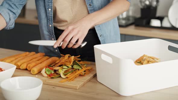 12 Video of woman sorting organic waste in the kitchen. Shot with RED helium camera in 8K. alt