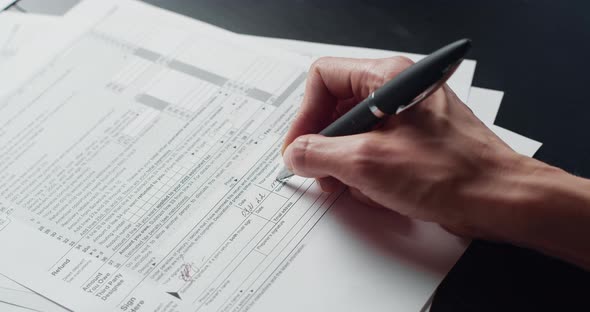 Woman Filling In The Tax Form alt