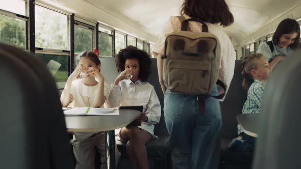 Multicultural Students Sitting School Bus in Morning alt