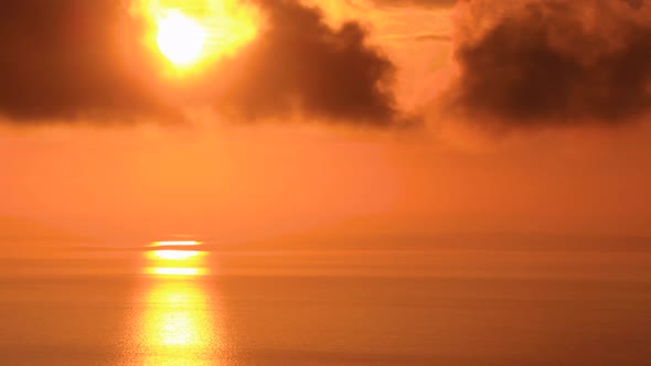 Sun Setting Through Clouds with Ocean Reflection and Islands Timelapse alt