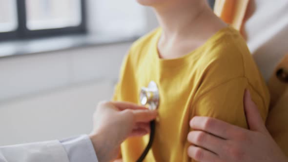 Mother Son and Doctor with Stethoscope at Clinic alt