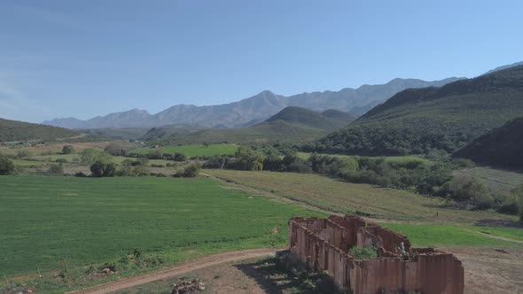 Drone flies low over desolate house on farm in rural South Africa alt
