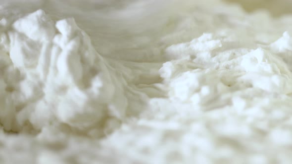 close up electric mixer preparation of whipped cream stiffening alt