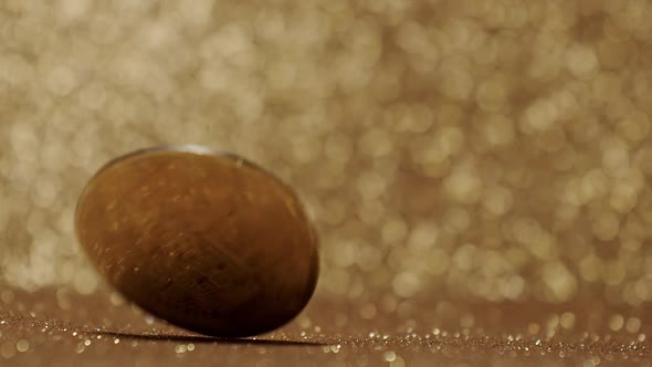 Close Up on gold background with bokeh. Bitcoin BTC coin. New virtual currency. alt