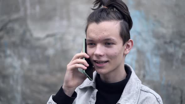 Portrait of Happy Young School Boy Speaking on Smartphone