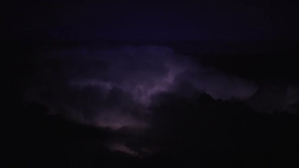 Thunderstorm Clouds at Night With Lightning