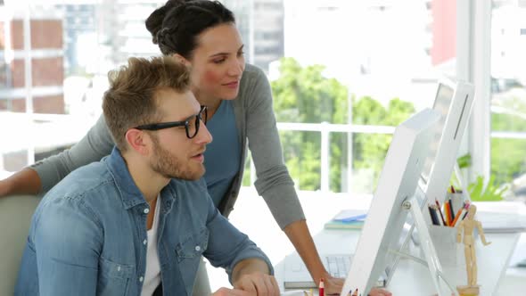 Young woman talking to her coworker alt