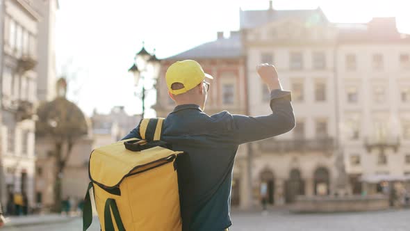 Yung Delivery Man Who is Going and Raising His Hand Up alt