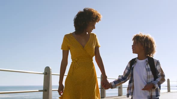Mother and son spending time together at beach alt