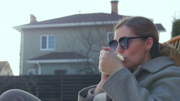 Woman With Coffee Winter Yard alt