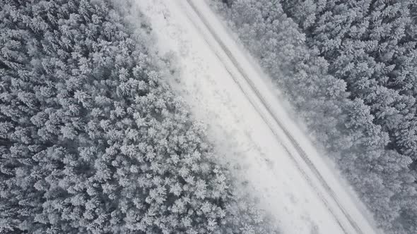 Aerial Top View From Drone Birds Eye View of Winter Landscape and Snowy Ice Road Car Moving on Area