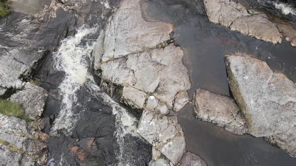 Brown Stream Water Flowing On The Rocky Landscape In The Wicklow Mountains, Ireland - aerial drone alt