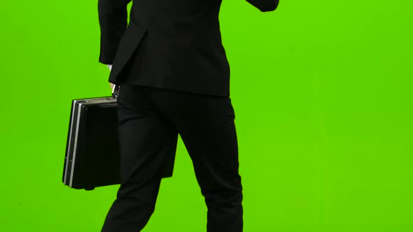 Businessman He Has a Diplomat in His Hands, the Phone Rings and He Starts To Run. Green Screen. Back alt