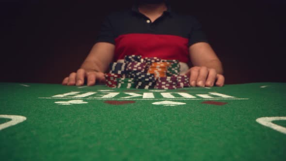 Male Player Betting All Chips in While Playing in Casino Close Up