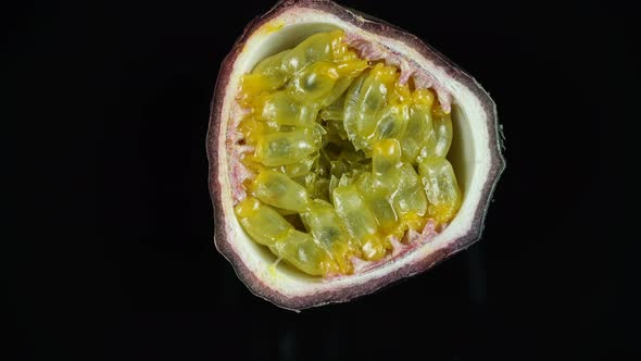 Rotating Tropical Fruit Passion Fruit On A Black Background.