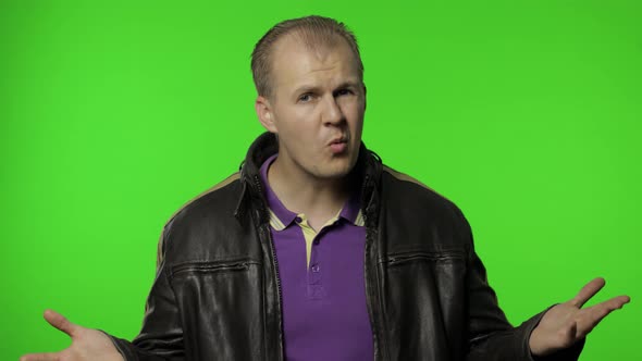 Annoyed Rocker Man Raising Hands in Anger and Shouting What, Why, How, Quarreling for Troubles alt