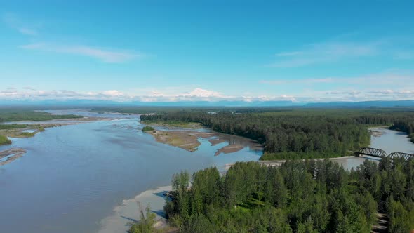 4K Drone Video of Alaska Railroad Train Trestle with Mt. Denali in Distance during Summer alt