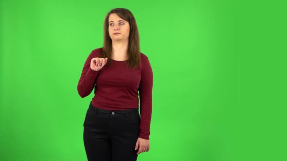 Pretty Girl Talking About Something Pointing at Him, Copy Space. Green Screen alt