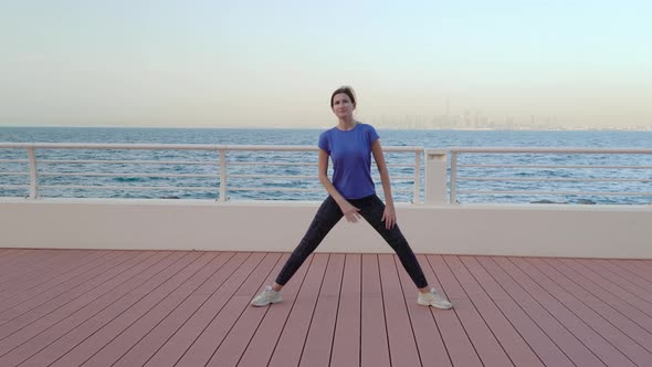 Girl Does Stretching Near Sea