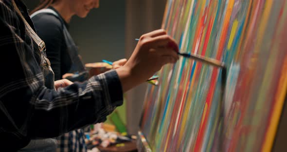 Side View of Two Smiling Women Developing Passion Together Painting an Abstract Picture in Their alt