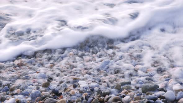 Pebbles on beach, close up alt