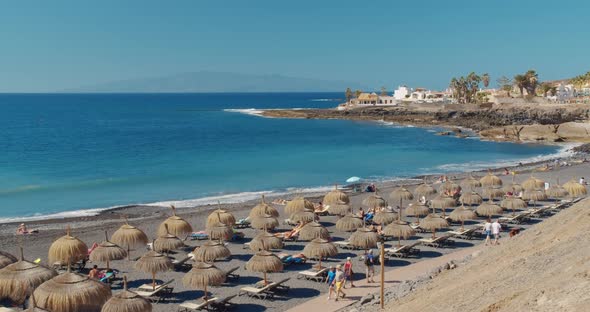 Summer Beach with Umbrellas and Turquoise Ocean Water From. Beach on a Sunny Day in Tenerife, Spain alt