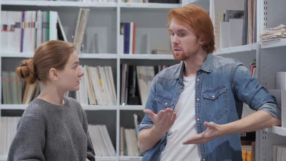 Creative Wise Man Discussing Idea with Young Woman at Work alt