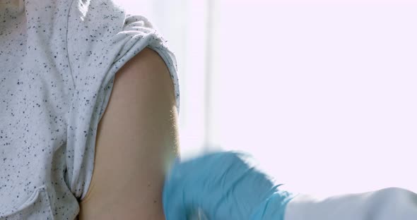 Vaccination concept. The doctor makes an injection of the vaccine against the virus. alt