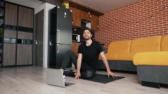 Fitness Male Athlete Practicing Online Exercises on Floor a Mat Using Laptop at Home in Living Room alt